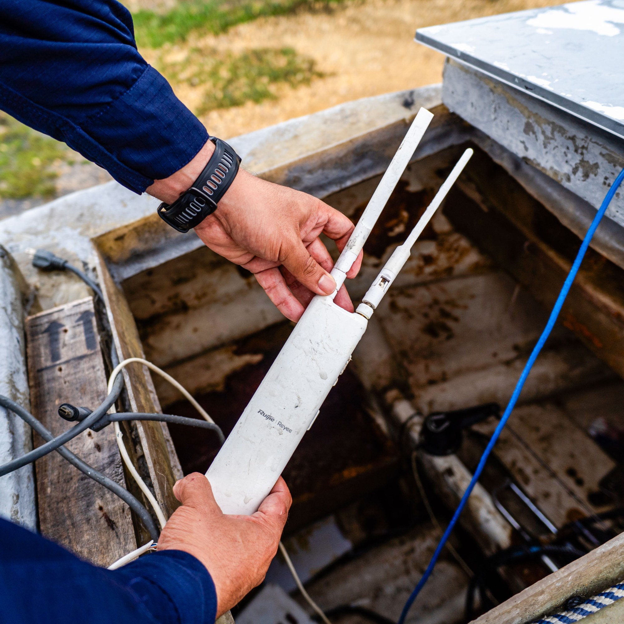hands holding a Starlink antenna